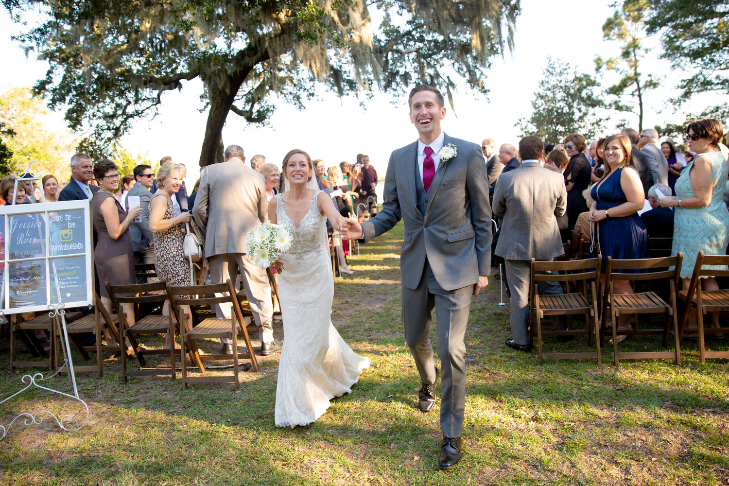 Bride & Groom excitedly walk down the aisle at their outdoor wedding ceremony at Sunnyside Plantation. 
