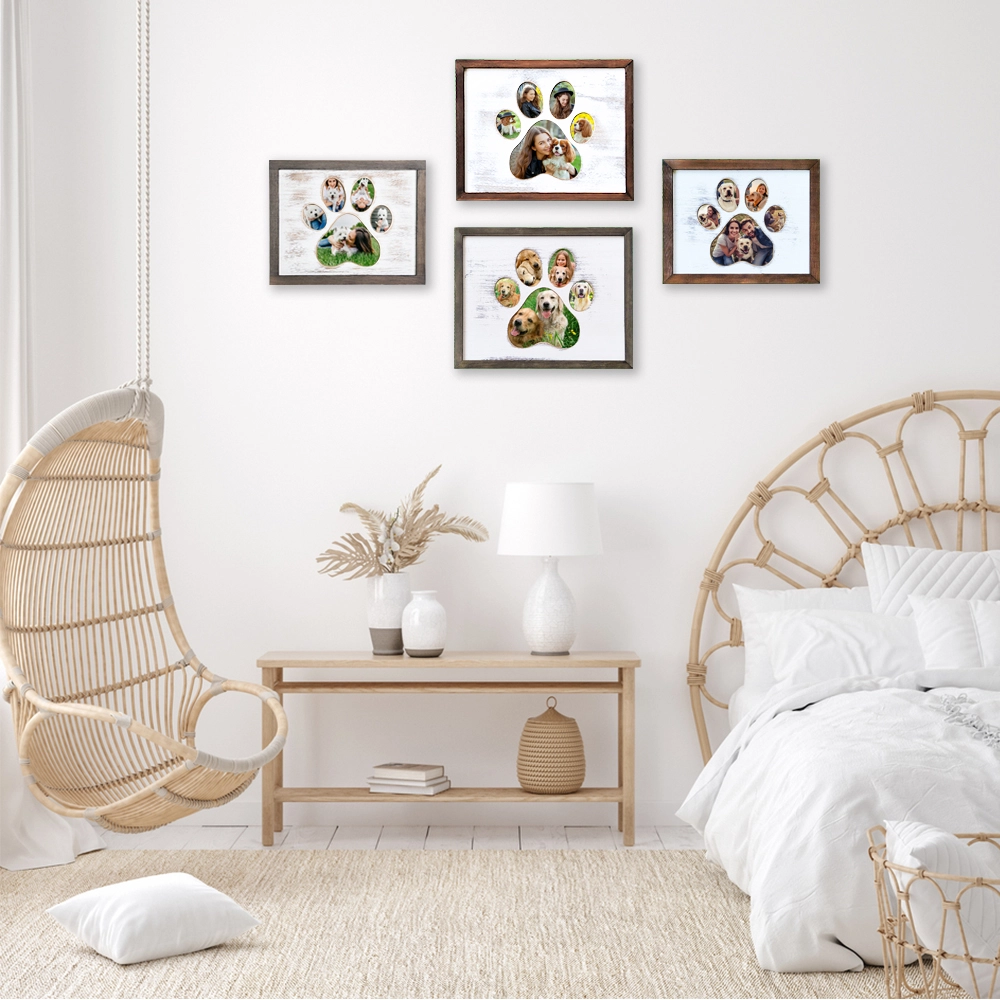 Bright bedroom with four framed paw print collages hanging above a light wood console table. The room includes wicker chairs, a white bed, and soft neutral décor.
