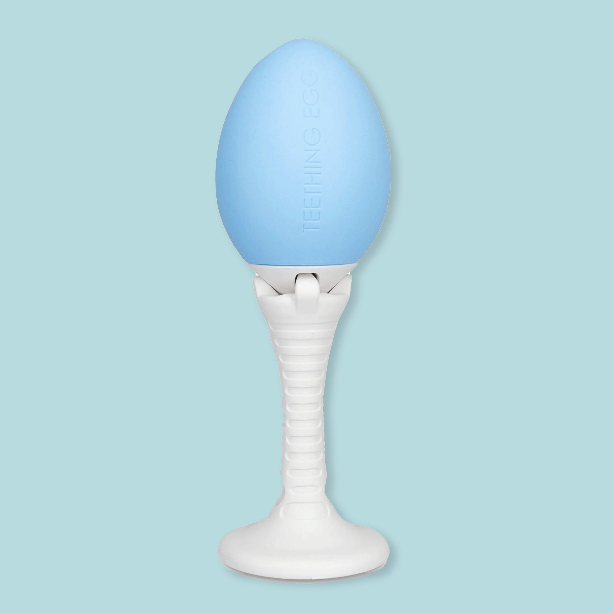 white grippie stick handle attached to teething egg on light blue background